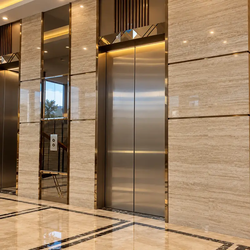 Marble-clad lift lobby with steel lift doors