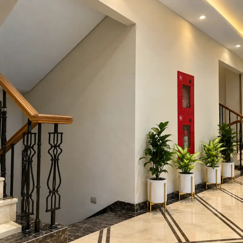 Staircase lobby with planters and marble floor